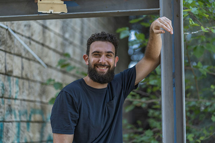 Man with beard smiling casually outdoors, portraying a guy who considers woman his girlfriend after one date. Man with beard smiling casually outdoors, portraying a guy who considers woman his girlfriend after one date.