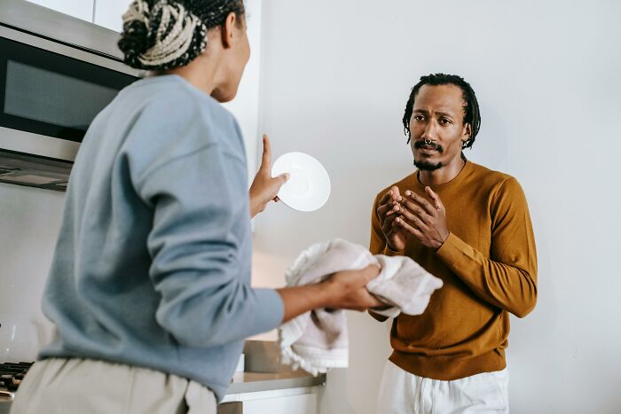 A couple having a tense conversation in the kitchen, illustrating men who married out of pressure life updates.