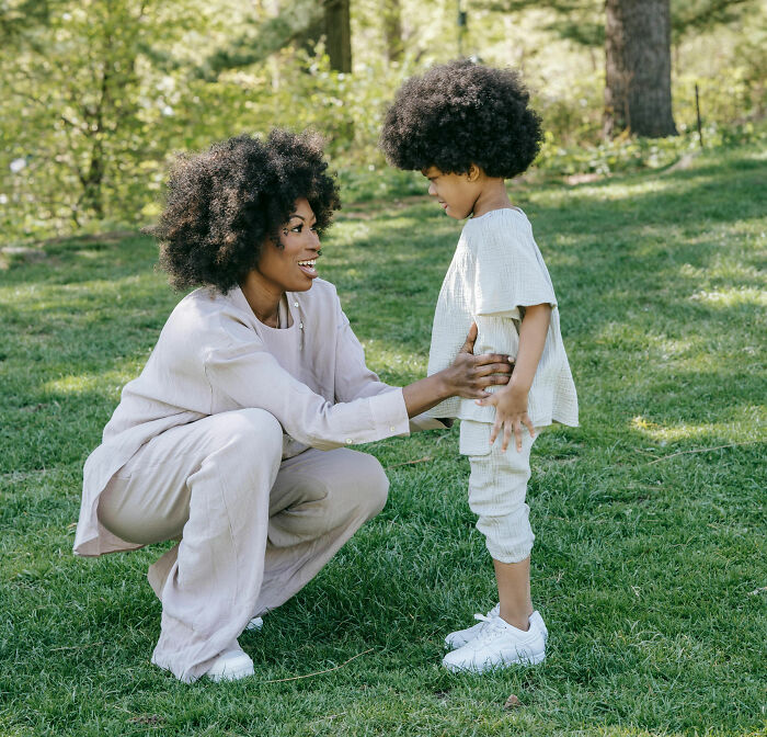 Mother and child in a park, sharing a moment of connection and parenting hacks to save sanity outdoors.
