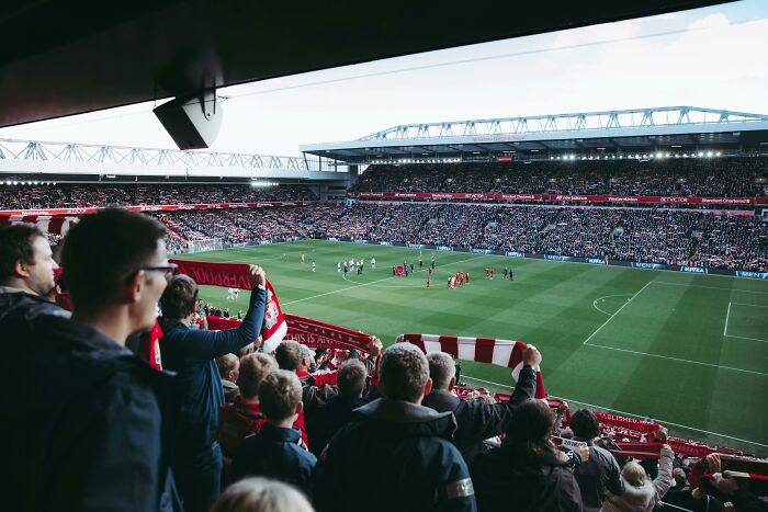 Crowd in stadium watching soccer match, highlighting how subtle misogyny affects women’s daily lives in sports settings.