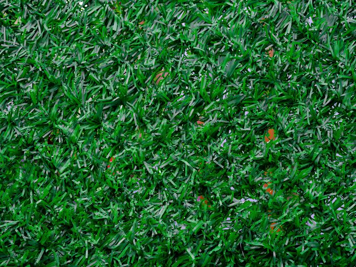 Close-up of green artificial grass texture illustrating things people used to spend hours doing now seen as pointless.