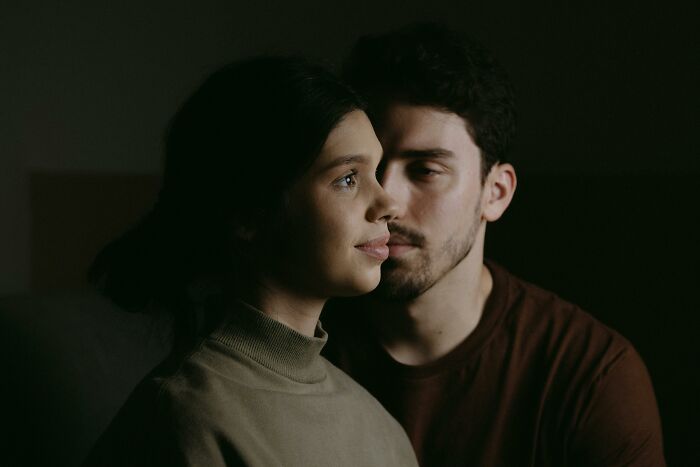 A thoughtful couple in dim light, reflecting on how to handle challenging scenarios with kindness and understanding. A thoughtful couple in dim light, reflecting on how to handle challenging scenarios with kindness and understanding.