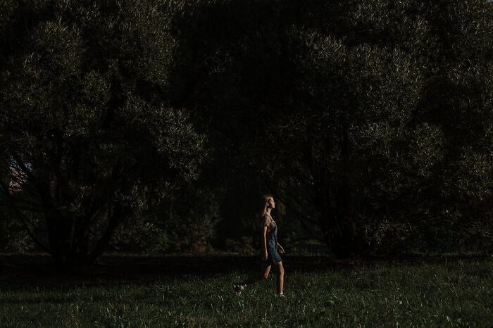 Woman walking alone in a dark park illustrating things women are not allowed to do that men can do freely.