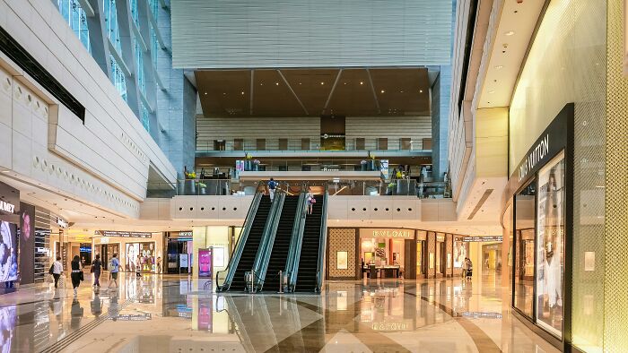 Interior of an abandoned department store with escalators and empty walkways, site of ancient skeletons discovery by archaeologists. Interior of an abandoned department store with escalators and empty walkways, site of ancient skeletons discovery by archaeologists.