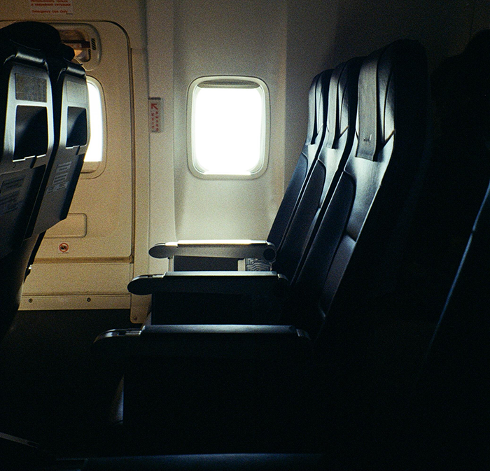 Airplane seats with a window view, illustrating the topic of buying two seats for comfort on flight for an obese passenger. Airplane seats with a window view, illustrating the topic of buying two seats for comfort on flight for an obese passenger.