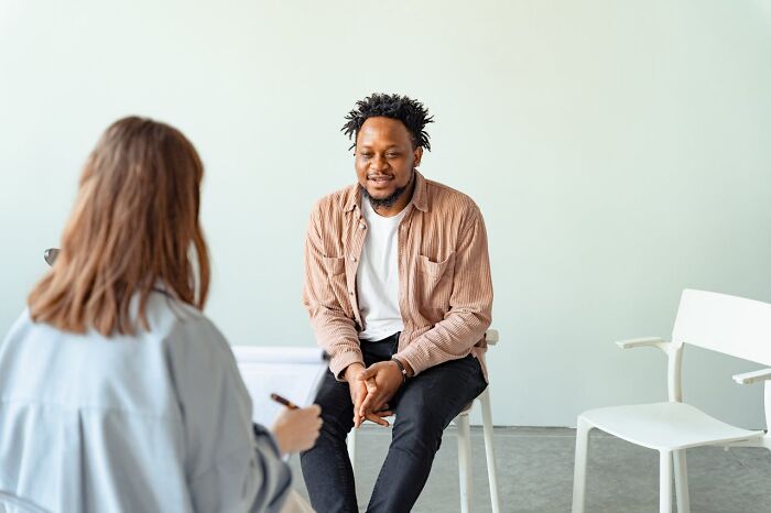 Man and woman having a serious conversation in a minimal room highlighting things women are not allowed to do.