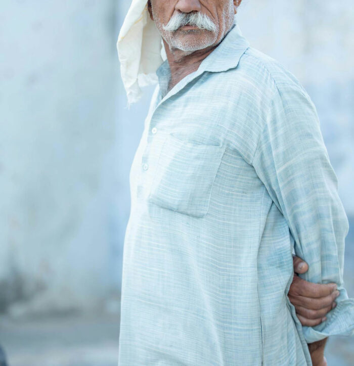 Elderly man with white mustache and headscarf standing outdoors, evoking creepy stories in dark woods atmosphere. Elderly man with white mustache and headscarf standing outdoors, evoking creepy stories in dark woods atmosphere.