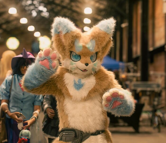 Person in a colorful furry costume at an event, unrelated to shocking school incidents or hypnosis stories