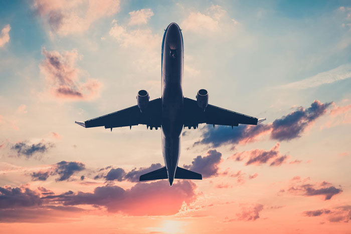 Airplane flying at sunset with dramatic sky, illustrating family eyes passenger's paid seat conflict during journey. Airplane flying at sunset with dramatic sky, illustrating family eyes passenger's paid seat conflict during journey.