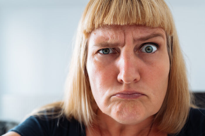 Close-up of a woman making a confused face, illustrating reactions to kaomojis and cultural appropriation debates.