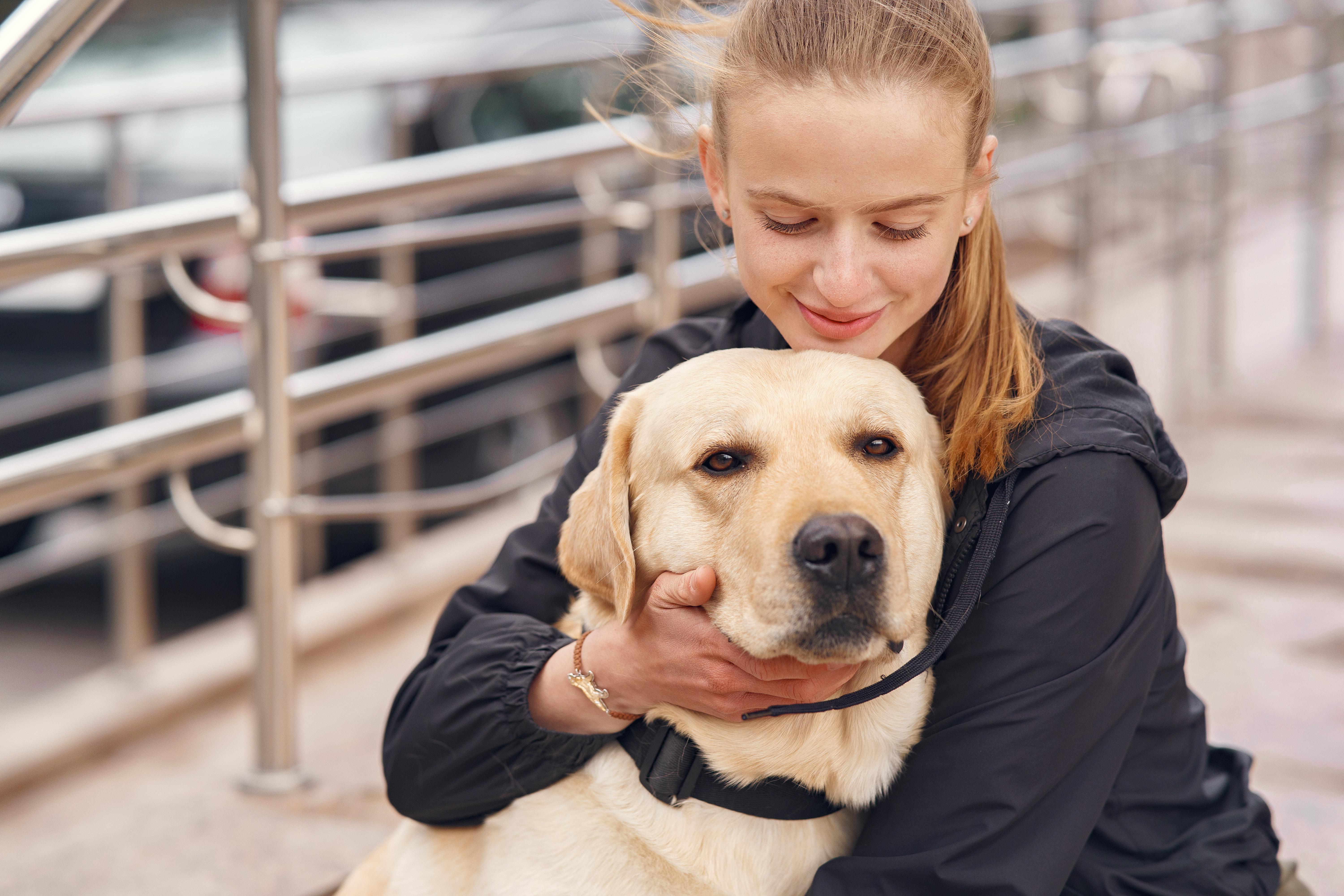 Young woman hugging a golden retriever service dog, reflecting on bride refusing SIL’s service dog at her wedding debate.