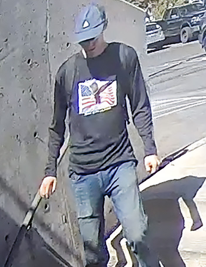 Man in a cap and flag shirt captured in CCTV footage showing the daring escape of the main suspect in fatal attack. Man in a cap and flag shirt captured in CCTV footage showing the daring escape of the main suspect in fatal attack.