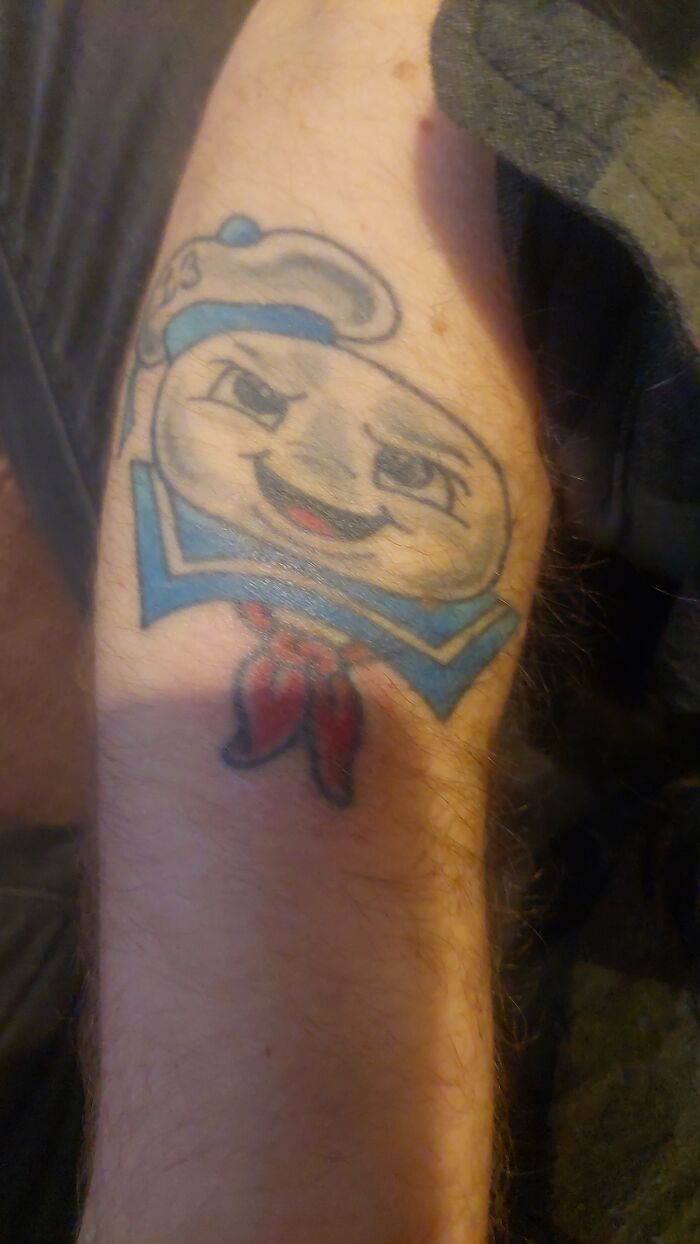 Tattoo of a cartoonish character on a person's arm depicting one of the worst client requests revealed by tattoo artists.