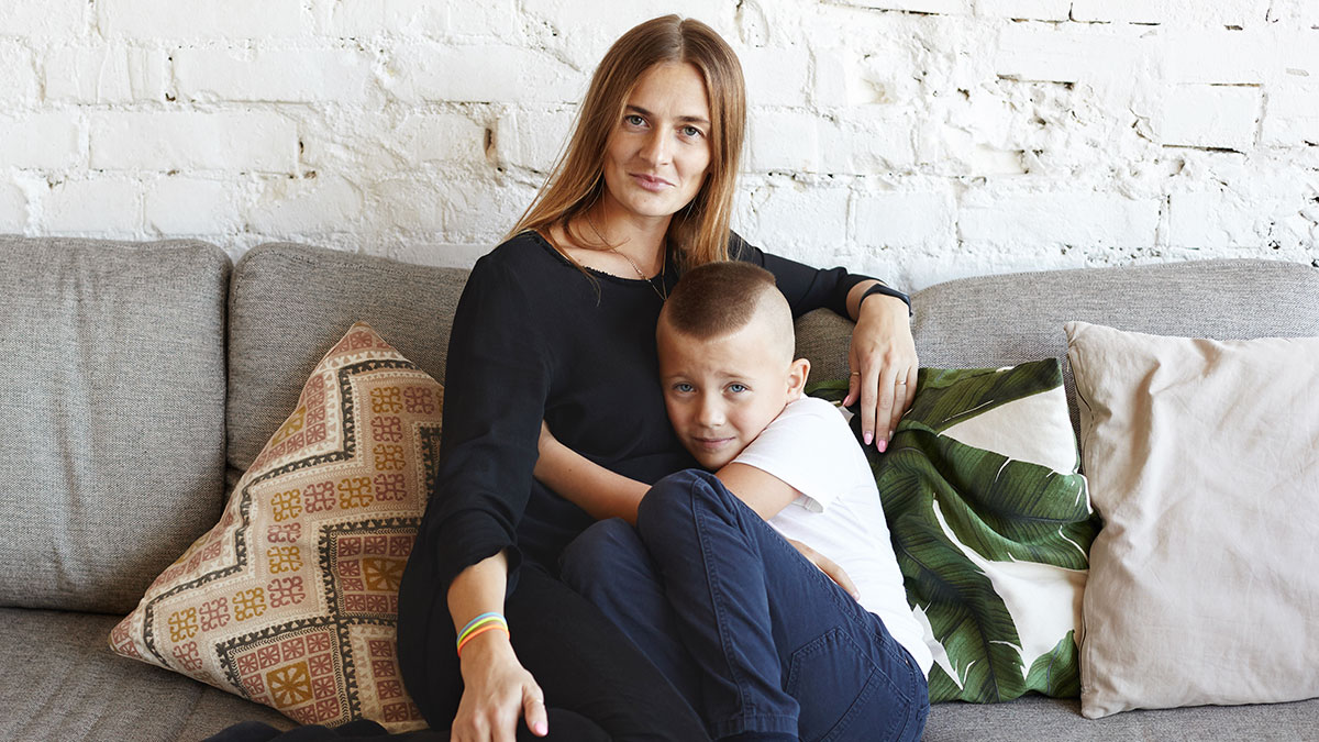 Mother and her young son sitting on a couch, illustrating a mom giving her baby up and wanting it back years later.
