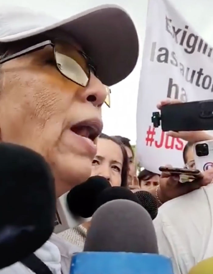 Woman speaking to reporters during a protest related to surgeon detained after fatal breast enlargement on teen. Woman speaking to reporters during a protest related to surgeon detained after fatal breast enlargement on teen.