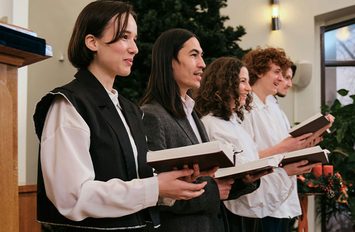 Group of diverse students holding books and smiling while standing together, illustrating school gossip and facts exposed.