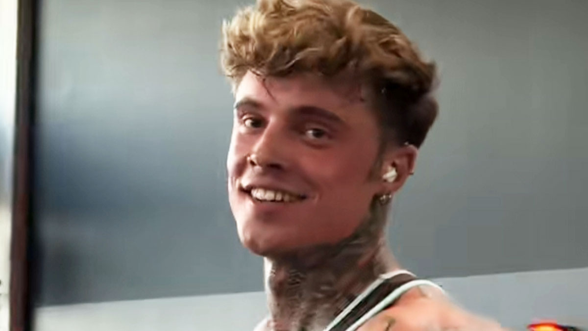 Young man with tattoos smiling indoors, showcasing one of the incredible transformations people went through.