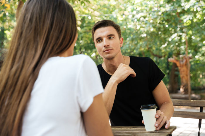 Young man and woman having an intense conversation outdoors, hinting at sister-boyfriend relationship drama in a casual setting. Young man and woman having an intense conversation outdoors, hinting at sister-boyfriend relationship drama in a casual setting.