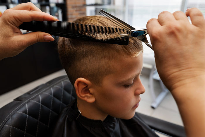 Young boy getting a haircut while sibling enforces strict gender roles after miscarriage, sparking family conflict and concerns. Young boy getting a haircut while sibling enforces strict gender roles after miscarriage, sparking family conflict and concerns.