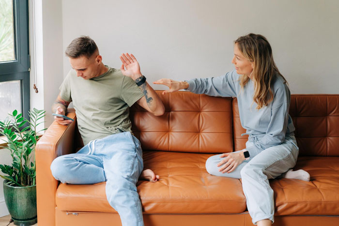 Woman confronting man on a couch, highlighting family tension and gender roles in a sibling relationship. Woman confronting man on a couch, highlighting family tension and gender roles in a sibling relationship.