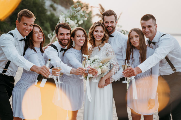 Bride and groom surrounded by wedding party raising champagne glasses, highlighting family favoritism and twin tension at ceremony. Bride and groom surrounded by wedding party raising champagne glasses, highlighting family favoritism and twin tension at ceremony.