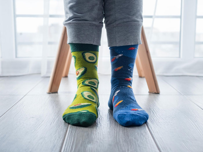 Person wearing colorful mismatched socks in a workplace setting, highlighting workplace harassment concerns. Person wearing colorful mismatched socks in a workplace setting, highlighting workplace harassment concerns.