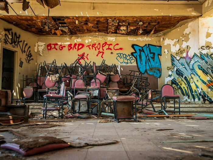 Abandoned room with broken chairs and graffiti, evoking terrifying true stories from beneath our feet explorers and workers.