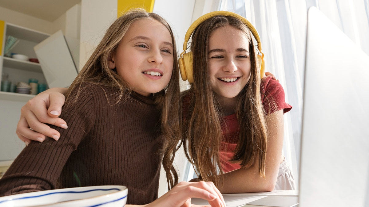 Two bored teens smiling and using a baby-naming website, sparking a trend with their weird name ideas.