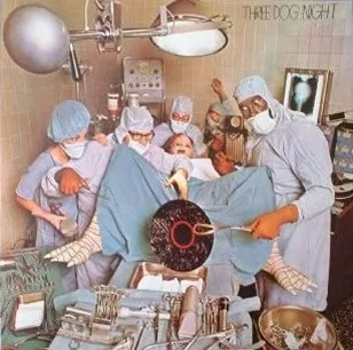 Surgeons performing an unusual operation on a patient in a vintage hospital room, showcasing a worst album cover.
