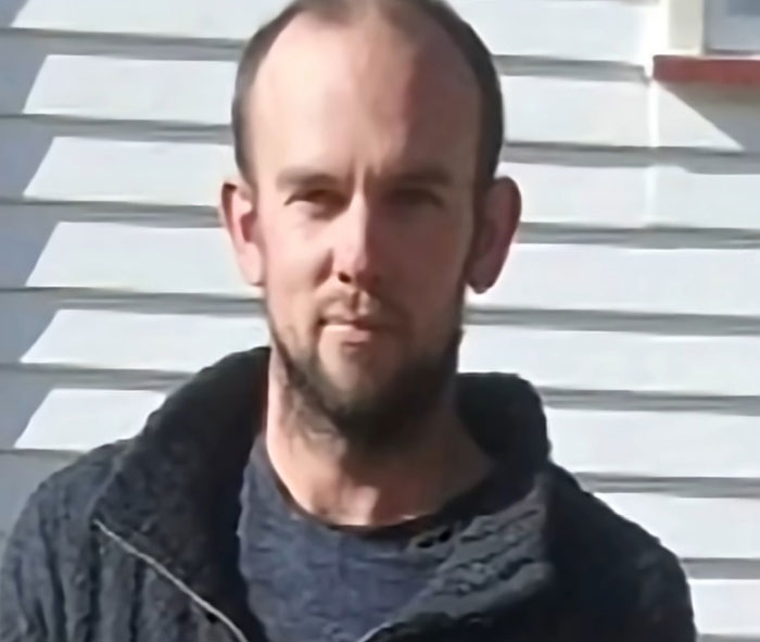 Man standing outdoors in front of white siding, related to mom of kids who vanished into wilderness story. Man standing outdoors in front of white siding, related to mom of kids who vanished into wilderness story.