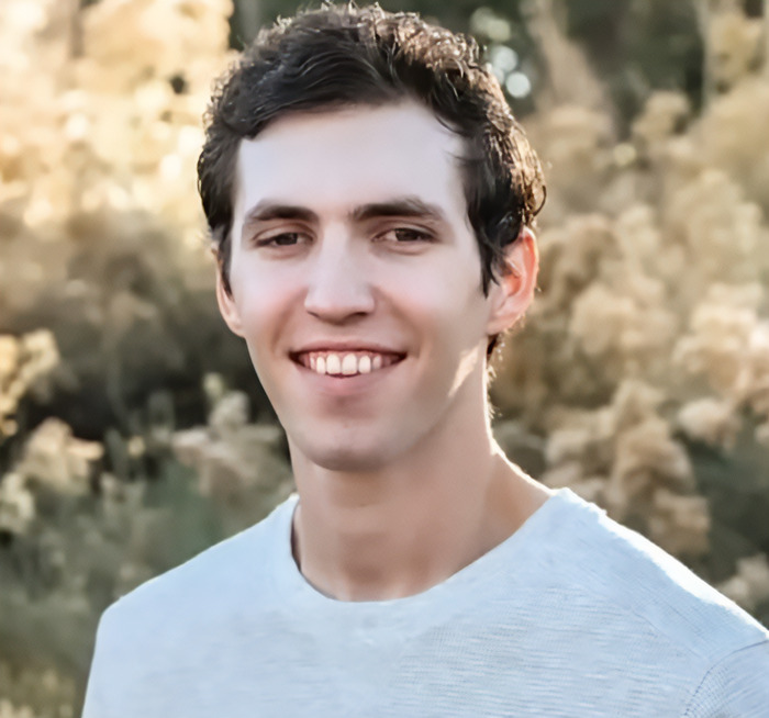 Tyler Robinson outdoors wearing a white shirt, people notice an eerie detail about the Charlie Kirk suspect appearance. Tyler Robinson outdoors wearing a white shirt, people notice an eerie detail about the Charlie Kirk suspect appearance.