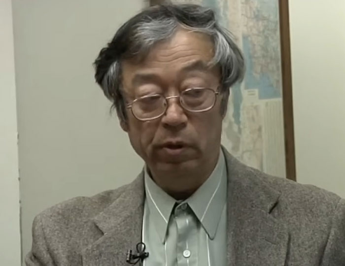 Older man with gray hair and glasses speaking in an indoor setting about bizarre and fascinating historical events.