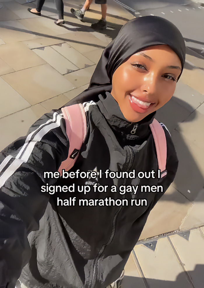 Young woman in running gear smiling before realizing she joined a gay running club, capturing an awkward moment viral online. Young woman in running gear smiling before realizing she joined a gay running club, capturing an awkward moment viral online.