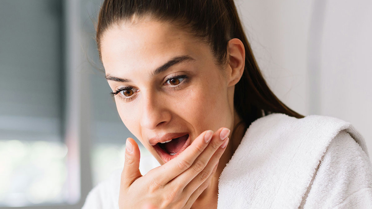 Young woman showing shock and surprise in the bathroom, capturing the courage to express what others could not tweet.