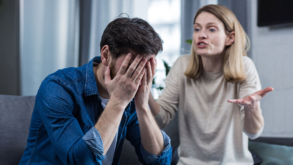 Man and woman having an intense argument indoors, highlighting man jokes about trading wife for younger woman concept.