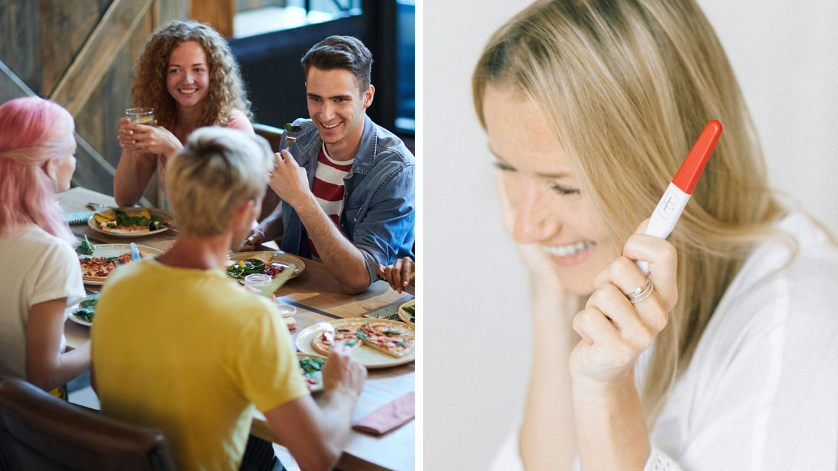 Woman holding a positive pregnancy test smiling while friends sit around a table enjoying a meal together