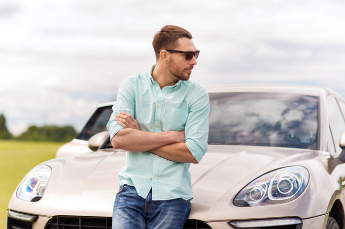 Man leaning on luxury vehicle outdoors, wearing sunglasses and casual shirt, highlighting hubby prioritizing luxury vehicle issue. Man leaning on luxury vehicle outdoors, wearing sunglasses and casual shirt, highlighting hubby prioritizing luxury vehicle issue.