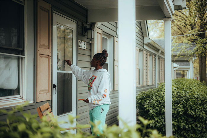 Person knocking on a friend's house door, illustrating situations that could lead to being permanently banned from a friend’s house.