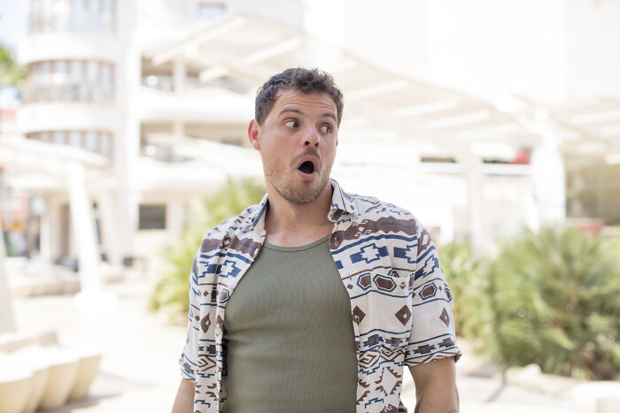 Man in patterned shirt with surprised expression, capturing the shock of sewer workers seeing bizarre things while working down there