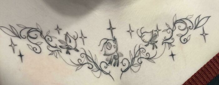 Delicate black ink tattoo with whimsical characters and floral swirls, illustrating unique client tattoo art requests.