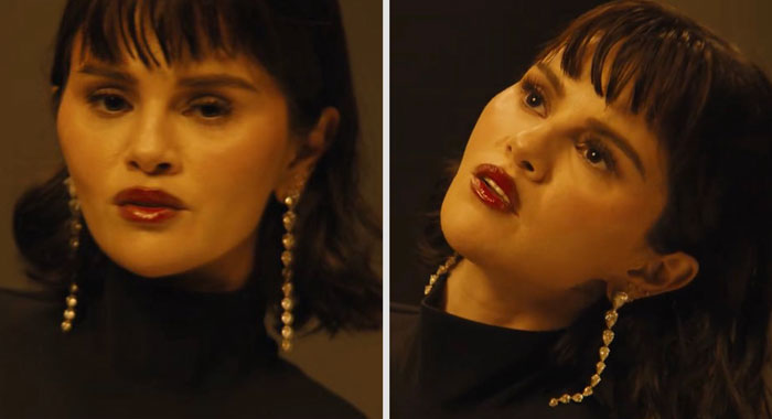 Selena Gomez in new music video with striking face and dark hair, wearing long pearl earrings and a black turtleneck. Selena Gomez in new music video with striking face and dark hair, wearing long pearl earrings and a black turtleneck.