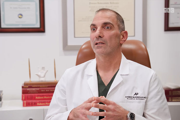 Doctor in white coat discussing urgent help for man with 4-lb face tumor in a medical office setting Doctor in white coat discussing urgent help for man with 4-lb face tumor in a medical office setting