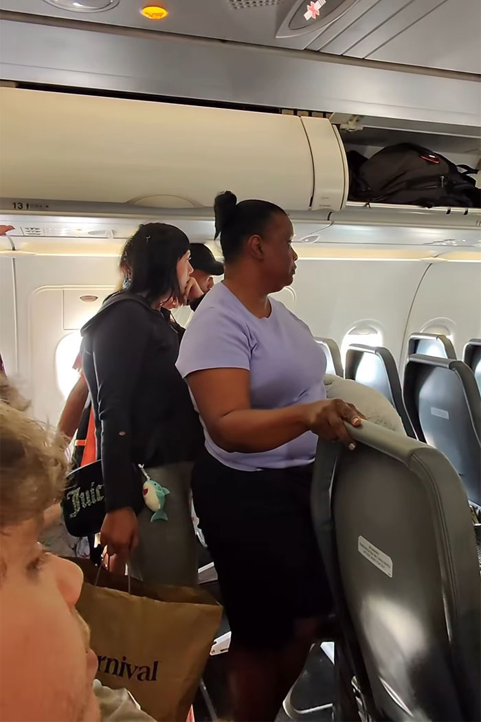 Woman blocking airplane aisle, refusing to let passengers exit until her daughter goes first, causing outrage onboard flight. Woman blocking airplane aisle, refusing to let passengers exit until her daughter goes first, causing outrage onboard flight.