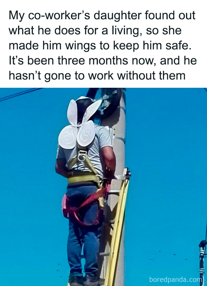 Man climbing utility pole wearing handmade wings, showcasing one of the adorable and wholesome posts to brighten your feed.