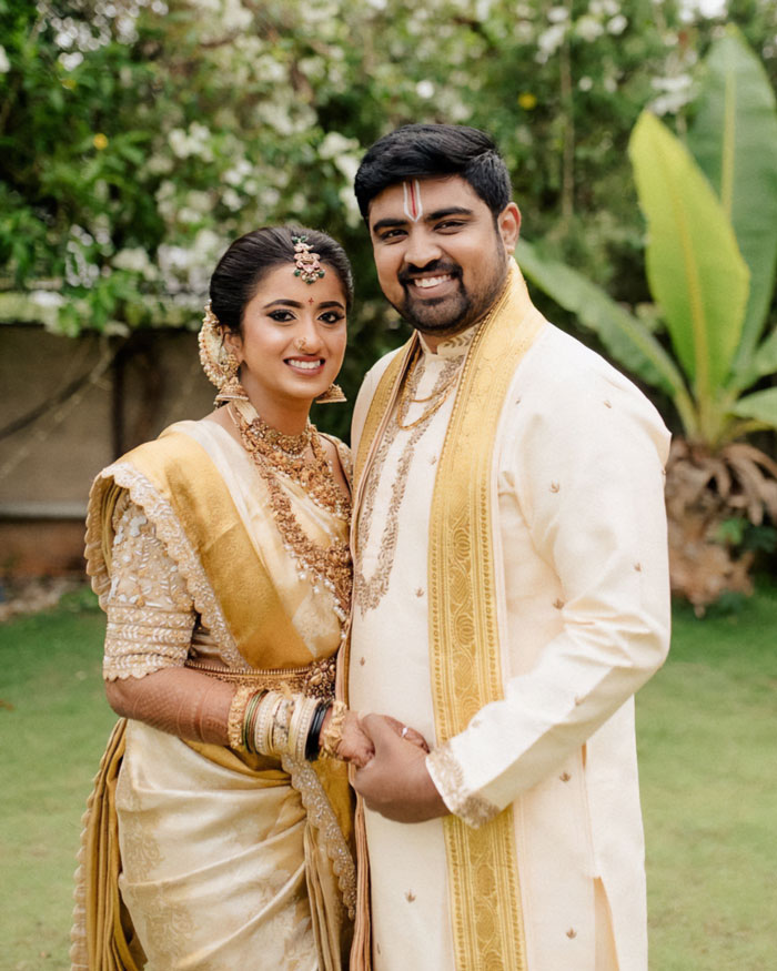 Indian couple in traditional wedding attire smiling outdoors, related to doctor who argued against wife’s autopsy news. Indian couple in traditional wedding attire smiling outdoors, related to doctor who argued against wife’s autopsy news.