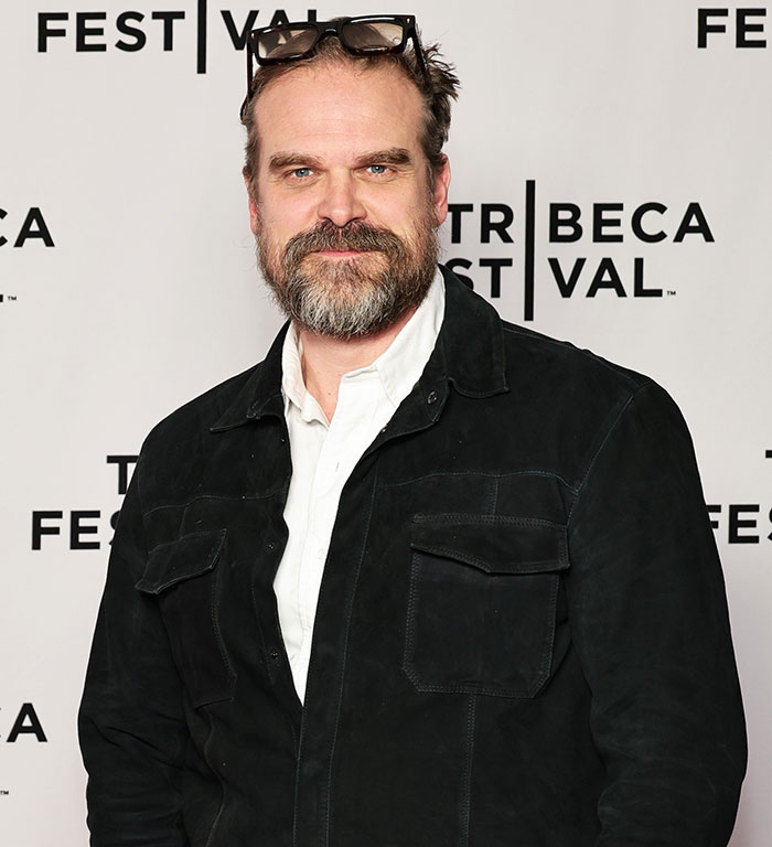 David Harbour at Tribeca Festival wearing a black jacket and white shirt, related to viral interaction with woman half his age. David Harbour at Tribeca Festival wearing a black jacket and white shirt, related to viral interaction with woman half his age.