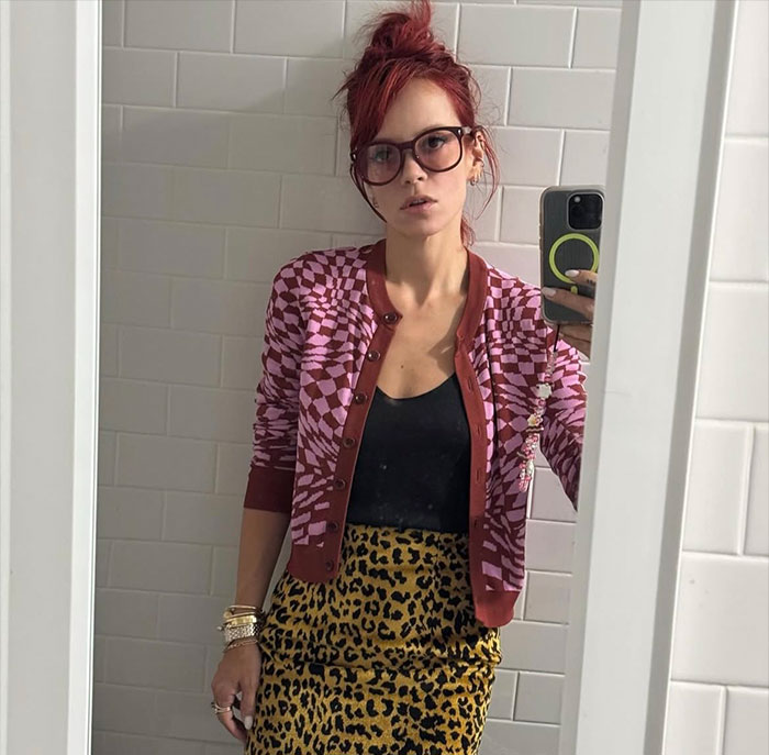 Lily Allen taking a mirror selfie in a patterned cardigan and leopard print skirt promoting new album and controversy. Lily Allen taking a mirror selfie in a patterned cardigan and leopard print skirt promoting new album and controversy.
