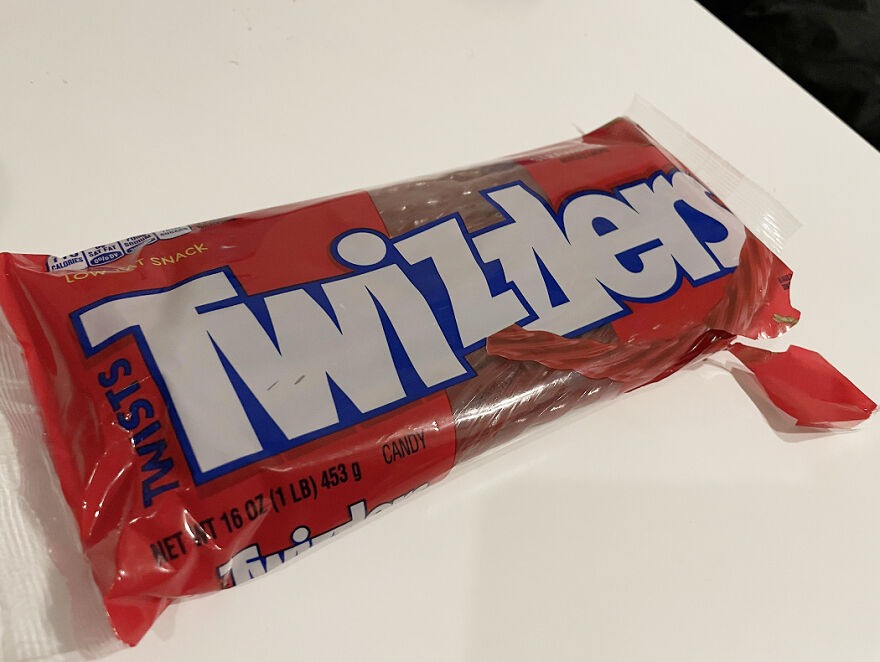 Twizzlers candy in a red package on a white surface, popular Halloween candy ranked by readers in 2025.