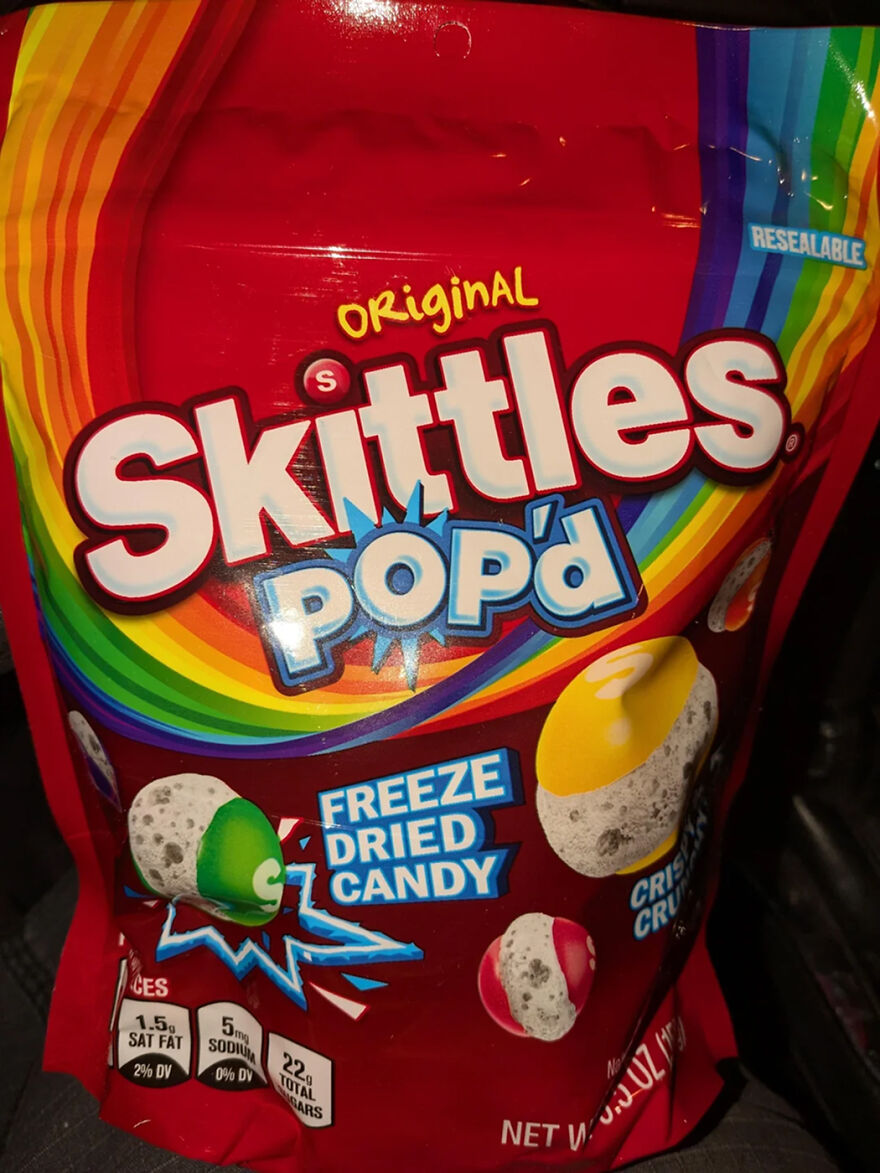 Skittles Pop'd freeze dried candy bag with colorful packaging, a popular Halloween candy choice in 2025.