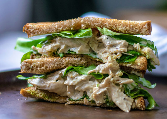 Close-up of a chicken sandwich with lettuce on toasted bread, highlighting the chicken sandwich main SEO keyword. Close-up of a chicken sandwich with lettuce on toasted bread, highlighting the chicken sandwich main SEO keyword.